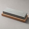 The Whetstone 1000/6000: a two-sided grey water stone seated in a plain hardwood cradle.