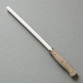 The Honing Rod 250: a white ceramic rod with a natural linen micarta handle on three brass pins and a steel collar.
