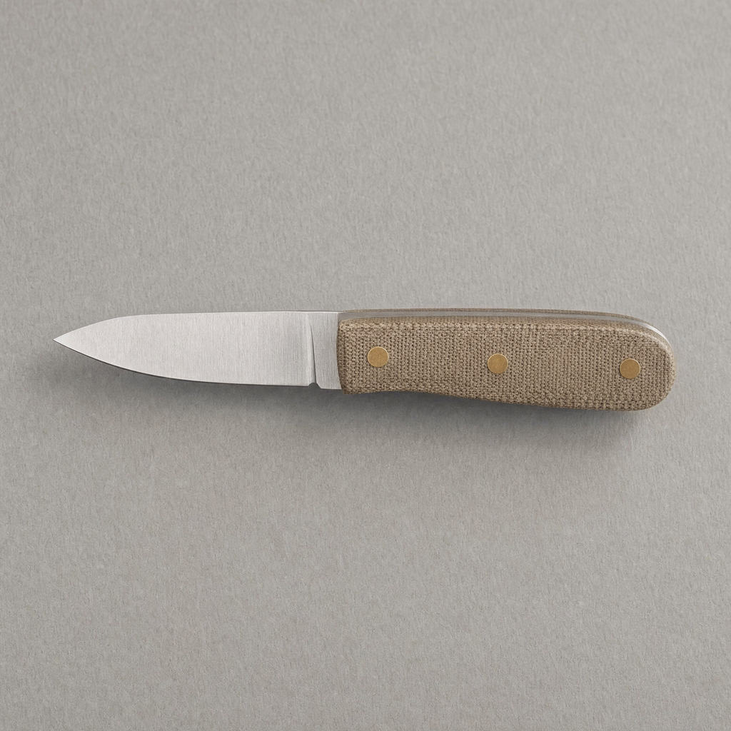 The Paring 90 seen from above: a short 90 mm satin stainless blade with a natural linen micarta handle on three brass pins.