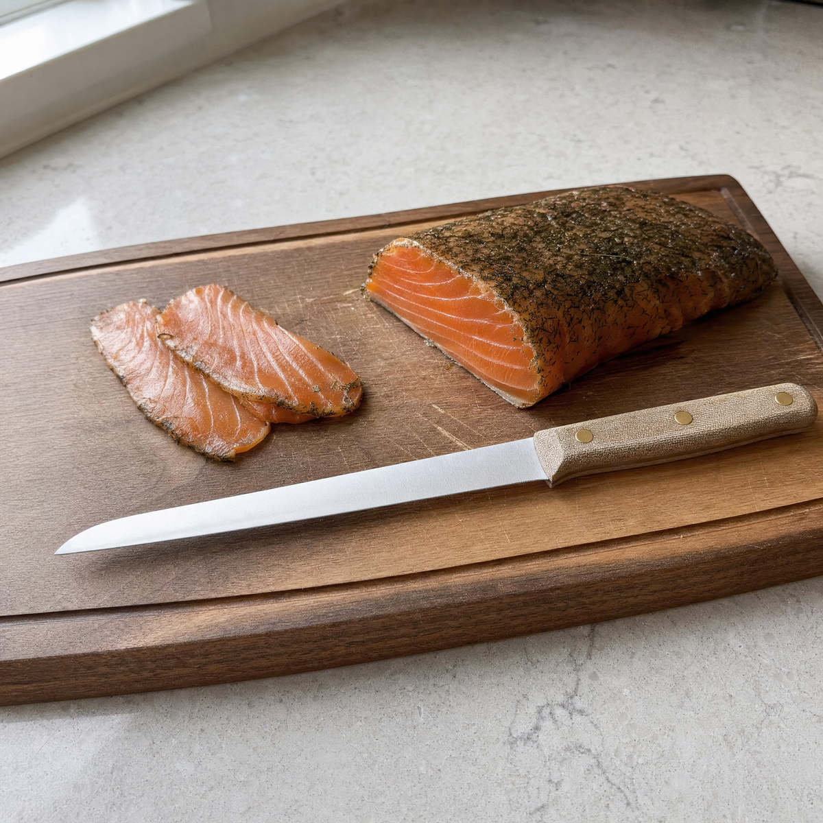 The Slicer 240 on a carving board beside a side of cured salmon with two slices cut.